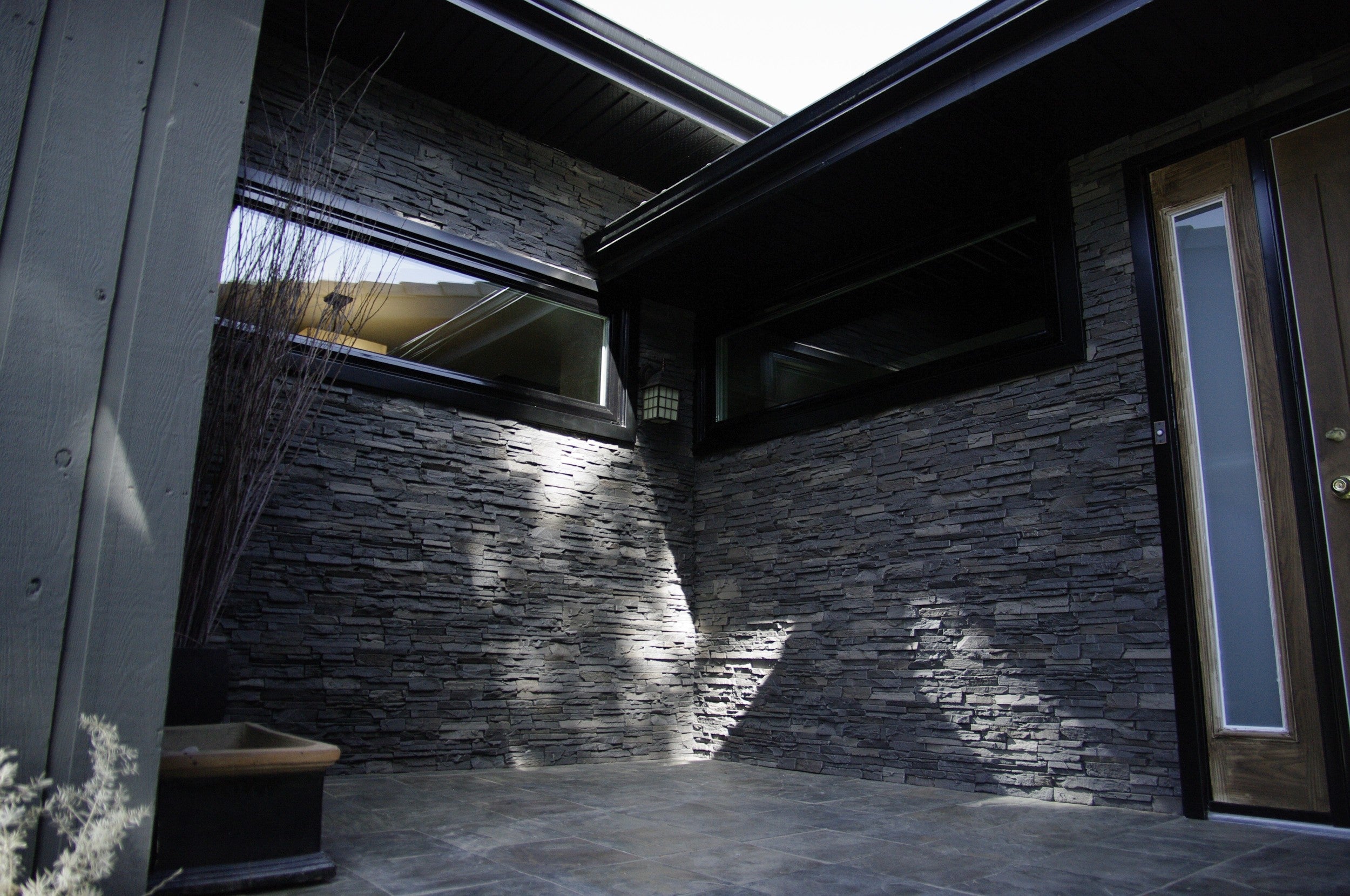 Quality Stone faux Stacked Stone panel in Dark Brown Blend — interlocking polyurethane wall panel, 2 sq ft per piece
